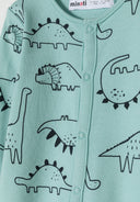 Detail of boys long sleeve sleepsuit in mint with dinosaur print and front press stud fastenings.