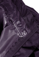 Detail of a purple kids packaway waterproof jacket showing the inner lining and elasticated cuff.