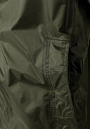 Detail of khaki men's waterproof jacket showing zippered pocket and fabric texture.