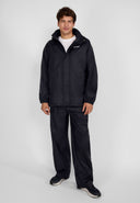 Men's black waterproof overpants, front view, featuring elasticated waistband and side openings.
