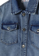 Close-up of a girls' denim dress with a collar and two front pockets.