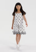 Girls dress with embroidered shoulder straps, white with black details, front view.