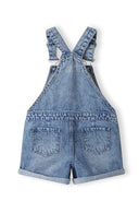 Back view of girls' short jeans dungarees with adjustable straps and two back pockets.