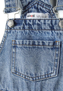 Detail of girls' navy short jeans dungarees with adjustable braces and back pocket.