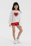 Girls cream fleece crew sweatshirt with heart print, front view.