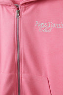 Detail of a pink oversized zip-through hoodie with embroidery and front pocket.