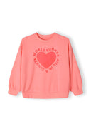Girls coral fleece crew neck sweatshirt with decorative heart print, front view.