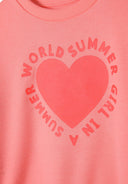 Detail of coral girls fleece crew neck sweatshirt with heart print.