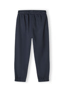 Detail of girls' jogger trousers with elasticated waistband and cuffs.
