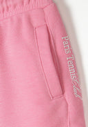 Detail of pink shorts with pocket and logo print.