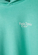 Detail of a green girls' hoodie featuring 'Paris Tennis Club' print.