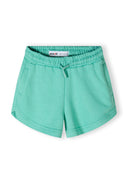 Detail of green shorts with elastic waistband and drawstring, featuring functional pockets.