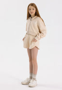 Girls beige zip-through hoody and shorts set, featuring ribbed cuffs and pockets.