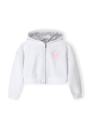 Girls zip-through hoodie in white with printed design, front view.