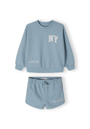 Girls blue crew neck sweatshirt and shorts set, featuring printed motifs and elastic waistband.