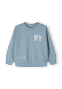 Girls crew neck sweatshirt in light blue with 'NY' print and ribbed cuffs.