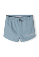 Detail of blue shorts with elastic waistband and 'New York City' embroidery.