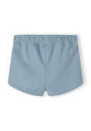 Detail of girls' blue shorts with elasticated waistband and side pockets.