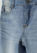 Detail of girls' light blue denim flare jeans with front pocket and button fastening.
