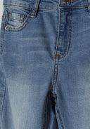 Detail of girls denim flare jeans in light blue with front pocket and button fastening.
