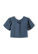 Girls blue blouse with frill sleeves and back bow detail, front view.