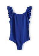 Girls one-piece swimsuit in cobalt blue with ruffled straps, front view.