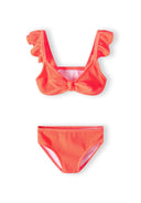 Girls two-piece bikini in bright orange, front view, featuring ruffled straps and a bow detail.