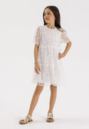 Girls short sleeve white dress with sequin flower details, front view.