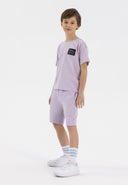 Boys lilac short sleeve t-shirt and shorts set, featuring a chest patch and elastic waistband.