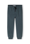 Detail of boys joggers in dark blue with elasticated waistband and side pockets.