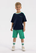 Boys short sleeve t-shirt and fleece shorts set in contrasting green, featuring a round neckline and decorative print.
