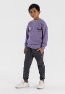 Boys grey joggers with pockets, front view, featuring elastic cuffs and adjustable waistband.