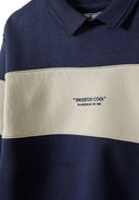 Close-up of a navy fleece jumper with a polo collar and contrasting cream panel.