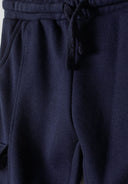Close-up of boys' navy cargo joggers with elastic waistband and drawstrings.