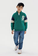 Boys half zip jumper in green with contrasting sleeve panels and ribbed cuffs.