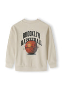 Boys oversized crew neck sweatshirt in cream, back view with basketball graphic.