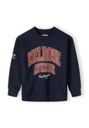 Boys navy fleece crew neck sweatshirt with front print and sleeve patch, front view.