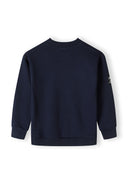 Back view of a navy boys fleece crew neck sweatshirt with ribbed cuffs.