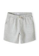Detail of grey shorts with elasticated waistband and side pockets.