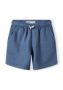 Boys' shorts in blue with elasticated waistband and side pockets, close-up.