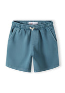 Detail of boys' green shorts with elasticated waistband and side pockets.