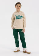 Boys oversized cream hoodie with kangaroo pocket, front view.