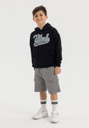 Boys oversized black hoodie with kangaroo pocket, front view.