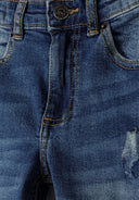 Close-up of boys' navy denim ripped straight leg jeans with front pockets.