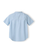 Boys grandad shirt in light blue, back view with stand-up collar and short sleeves.
