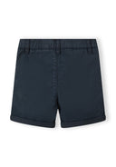 Detail of navy blue shorts with adjustable waistband and rolled hem.