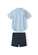 Boys grandad shirt in light blue with navy shorts, back view, features button fastening and adjustable waistband.