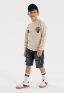 Boys black denim cargo shorts, front view, featuring large cargo pockets and drawcord waistband.