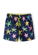 Boys board shorts, navy with colorful starfish print, front view, adjustable drawstring.