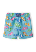 Boys board shorts in turquoise with colorful fish pattern, back view.